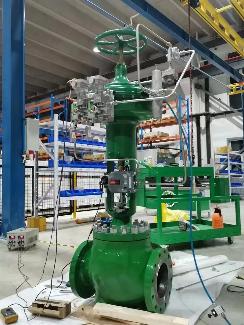 Fisher control valve with pneumatic diaphragm actuator, FIELDVUE DVC smart positioner, filter regulator and handwheel assembly in factory test environment, complete valve instrumentation setup for industrial process control